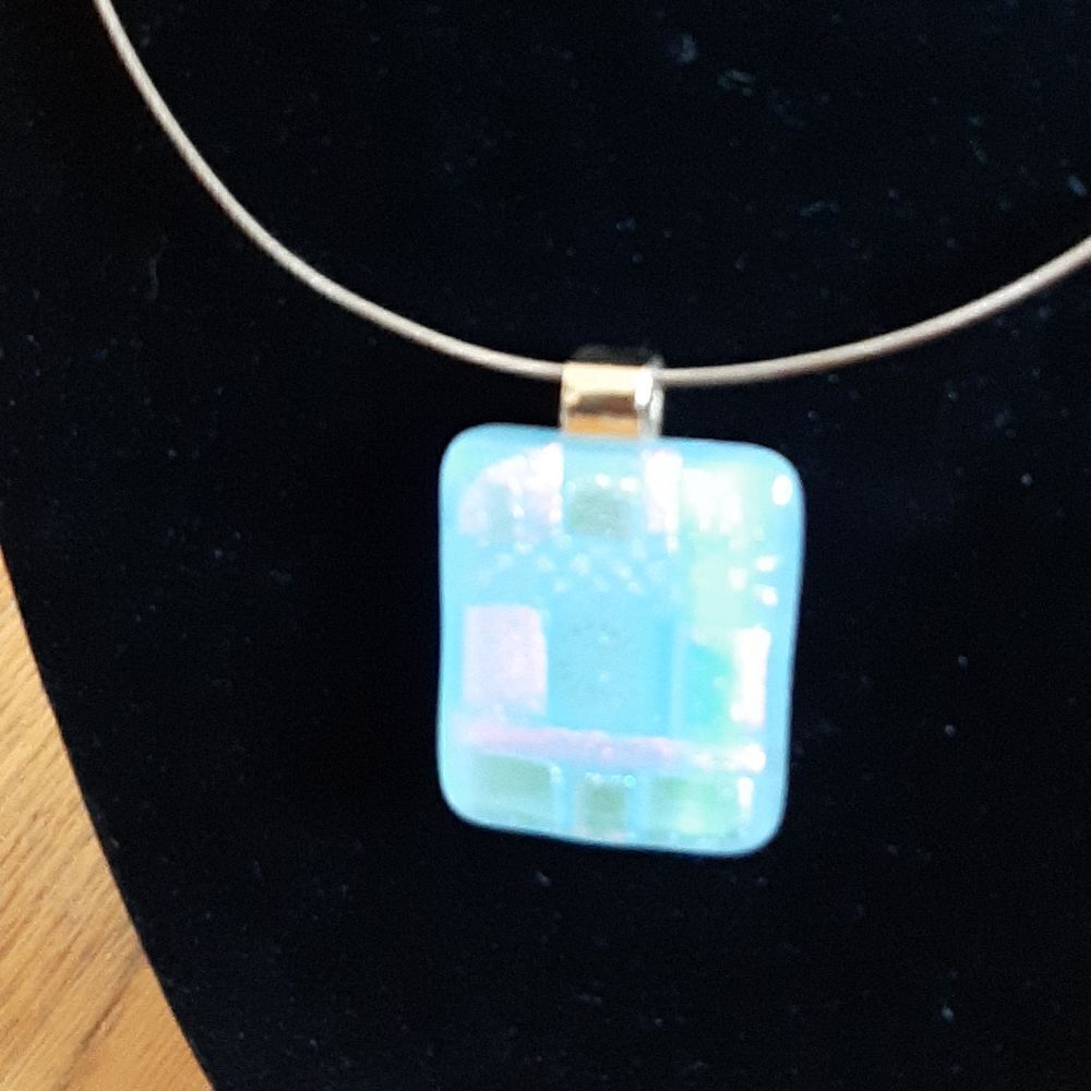 Gold toned collar necklace with pink and blue pendant